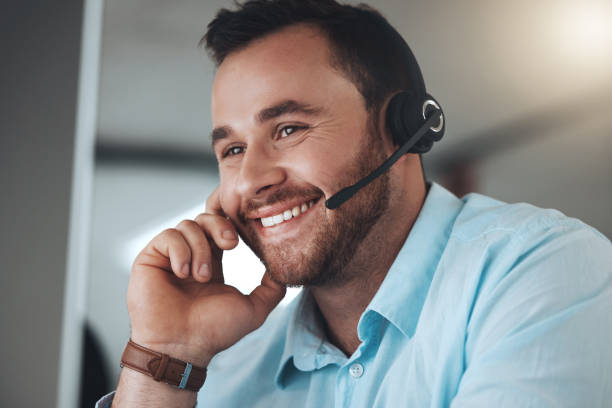 istock Shot of a young call centre agent sitting alone in his office and using his computer 1345478041