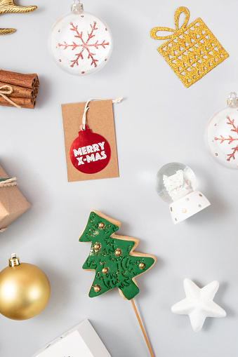 Christmas related objects and ornaments  flat lay on gray background with copy space