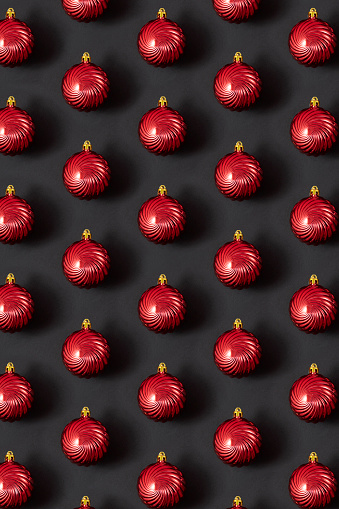 Christmas bauble ornaments in a row on black  background