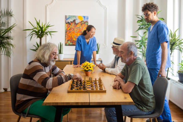 istock Senior men playing chess at nursing home 1345481454