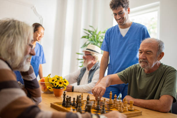 istock Senior men playing chess at nursing home 1345482510