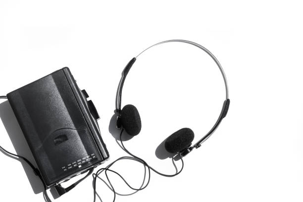 A black cassette player with headphones A black cassette player with headphones on a yellow background personal stereo stock pictures, royalty-free photos & images