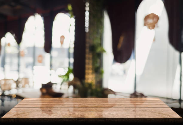 istock Empty wooden table top with lights bokeh on blur restaurant background 1345482750