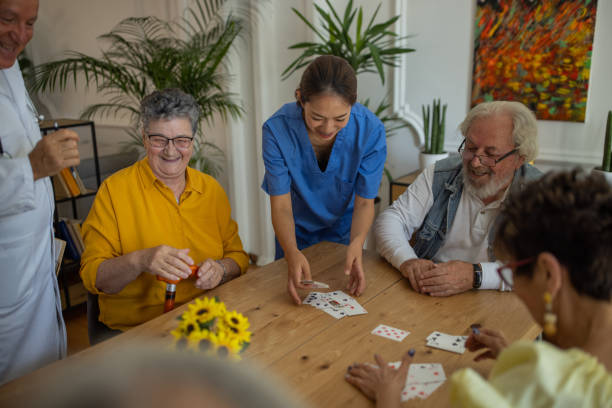 istock Senior people playing cards in retirement home 1345482859
