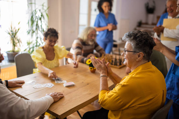istock Senior people having fun playing games in retirement home 1345483532