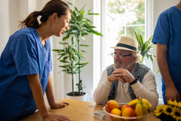 istock Nurse talking with senior patient in nursing home 1345483638