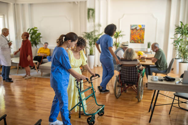 Usual day in crowded nursing home Usual day in crowded nursing home, healthcare workers working with senior people in nursing home retirement community stock pictures, royalty-free photos & images