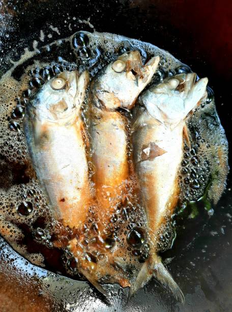 istock Frying Mackerel fish in iron cooking pan. 1345484957