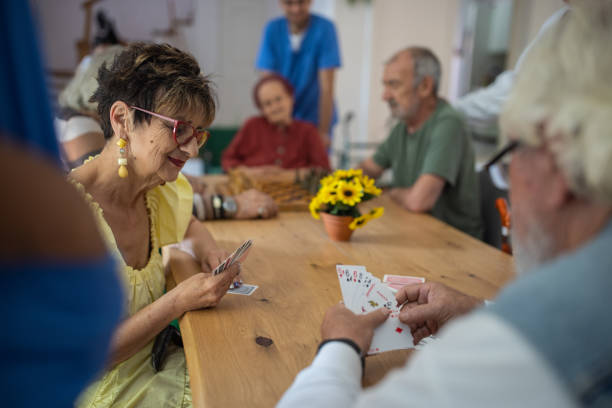 istock Senior people playing cards in retirement home 1345485039