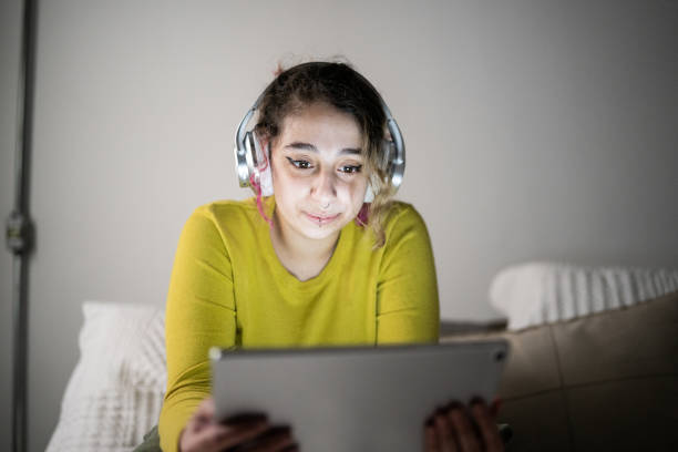 istock Young woman using a digital tablet at home 1345486590