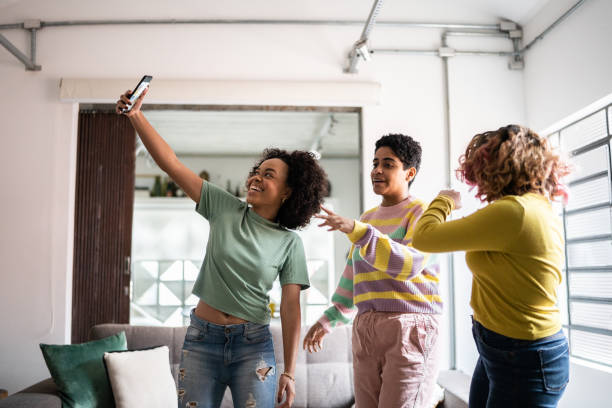 istock Friends filming themselves dancing (or on a video call) at home 1345486622