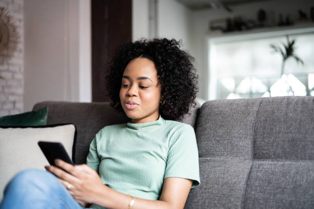 istock Young woman using a smartphone at home 1345486645
