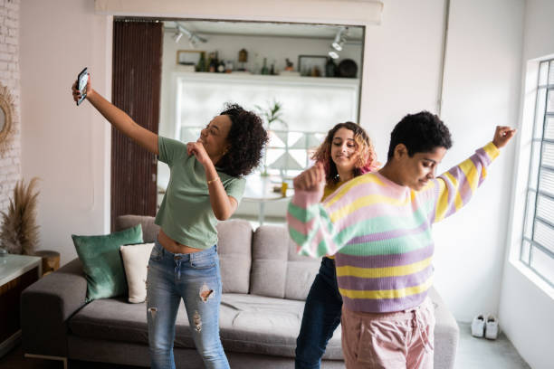 istock Friends filming themselves dancing (or on a video call) at home 1345486674