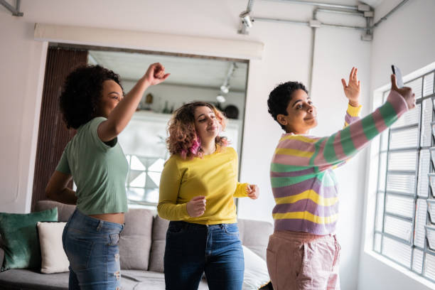 istock Friends filming themselves dancing (or on a video call) at home 1345486744