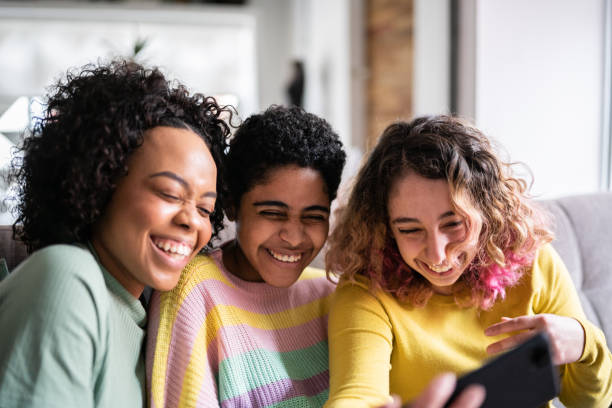 istock Friends watching something or on a video call on a mobile phone at home 1345487700