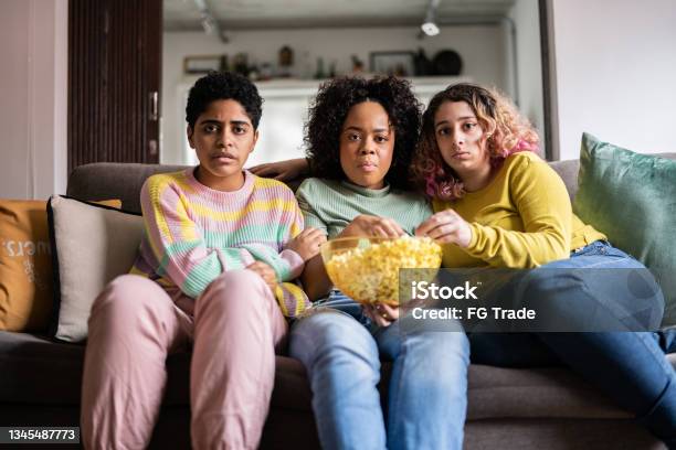 Friends Watching Tv And Eating Popcorn At Home Point Of View Stock Photo - Download Image Now