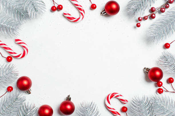 istock White Christmas background with Christmas tree branches and red baubles 1345487846