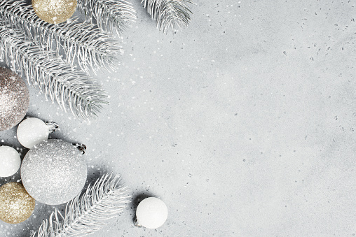 Christmas background with frosted Christmas tree branches and baubles, winter festive composition with copy space