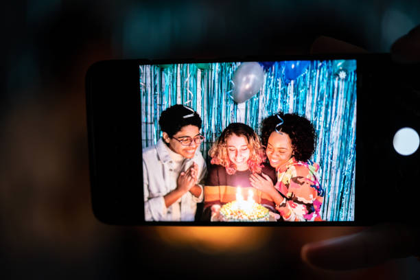 istock Device screen with girls celebrating birthday at home 1345488154
