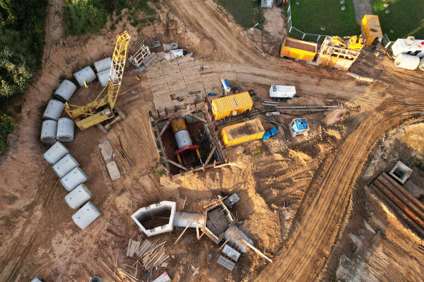 istock Concrete sewer pipes for laying external sewage system at construction site. 1345489006
