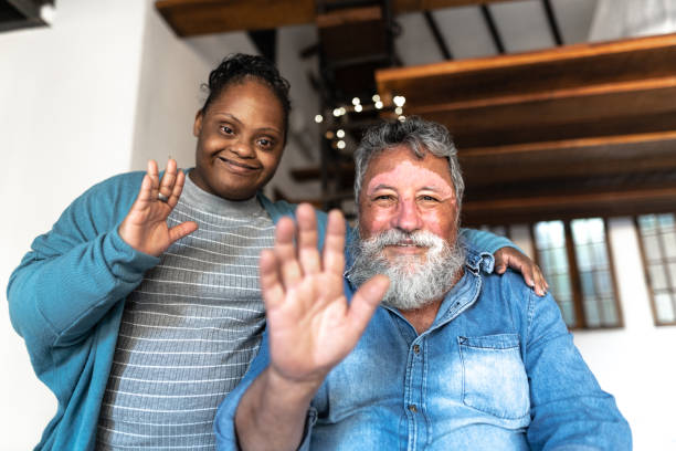 Father and daughter with special needs on a video call at home - webcam point of view Father and daughter with special needs on a video call at home - point of view man video call pov stock pictures, royalty-free photos & images