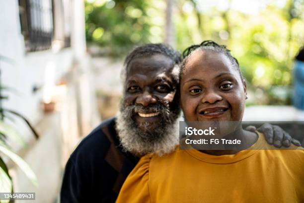 Portrait Of A Father And His Daughter With Special Needs At Home Stock Photo - Download Image Now