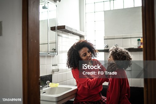 istock Mother talking to son in the bathroom in the morning at home 1345489698
