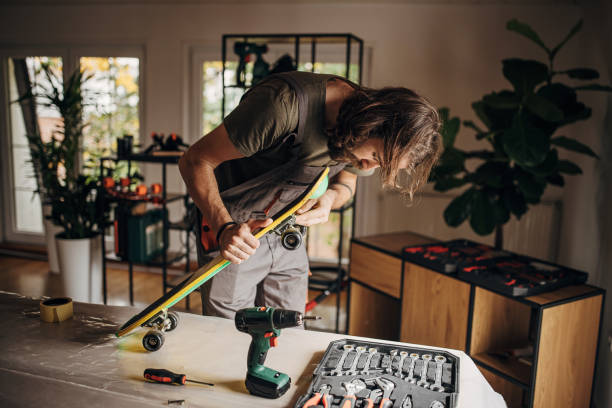 istock Young man repairing a skateboard 1345489850