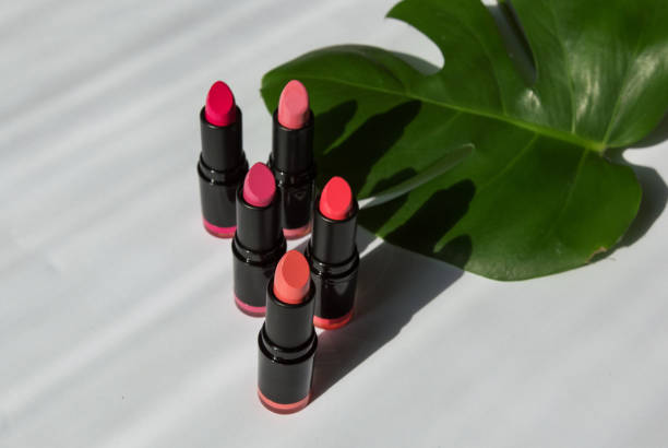 istock colored bright lipstick of various pink shades on a white background
 with leaf shadows 1345489991