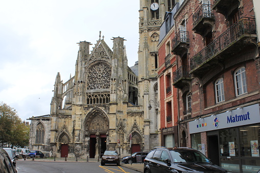Dieppe, France - sep 9, 2017: the ancient medieval decorative church saint-jacques in dieppe with the shopping street in front