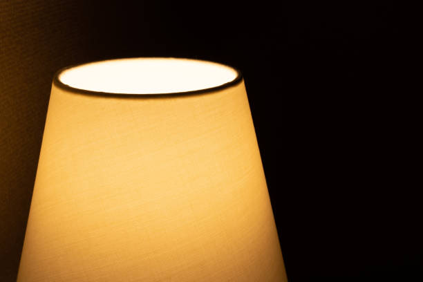 istock A bedside table lamp in the dark room. 1345493192