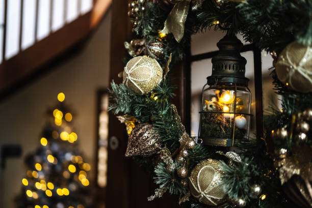istock Christmas wreath hanging in front door 1345494695