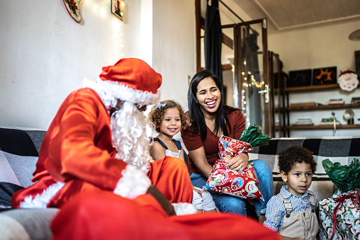 Santa Claus visiting kids on Christmas at home