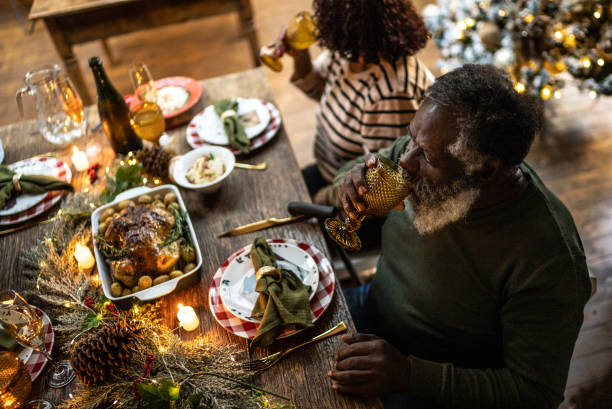 istock Senior man drinking on Christmas dinner at home 1345495806