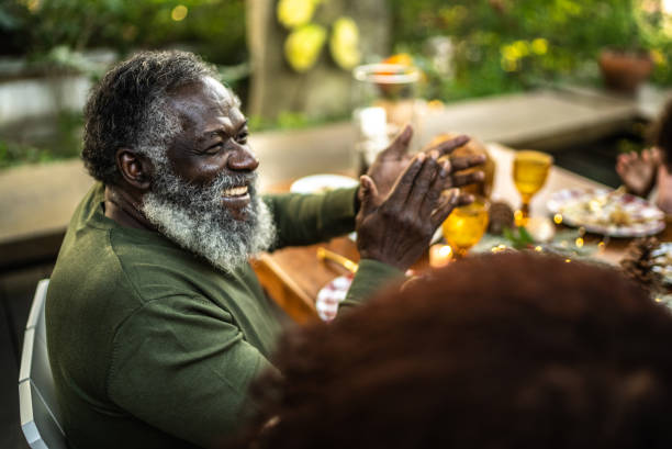 istock Senior man clapping at the table on Christmas at home 1345495829