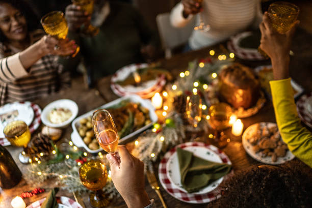 Family toasting on Christmas dinner at home Family toasting on Christmas dinner at home family reunion celebration stock pictures, royalty-free photos & images