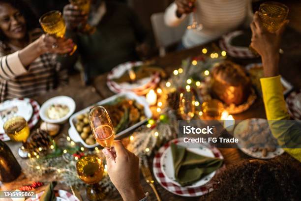 Family Toasting On Christmas Dinner At Home Stock Photo - Download Image Now - Christmas, Dinner, Family
