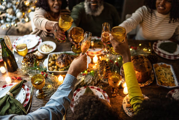 istock Family toasting on Christmas dinner at home 1345495872