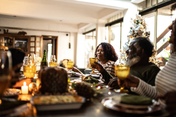 istock Family toasting on Christmas dinner at home 1345495879