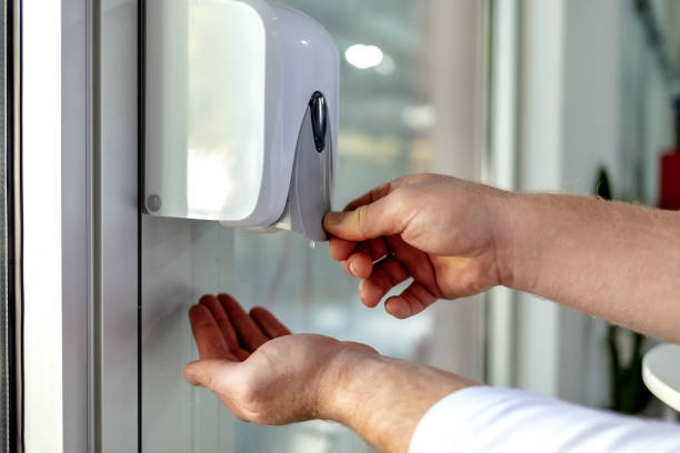 istock Man hand using wash hand sanitizer gel dispenser automatic machine for prevent Coronavirus. 1345496474
