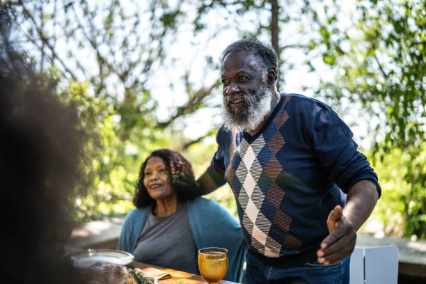 istock Senior man saying grace before Thanksgiving lunch at home 1345496507