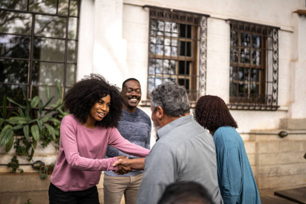 istock Neighbors greeting each other at front house 1345496508