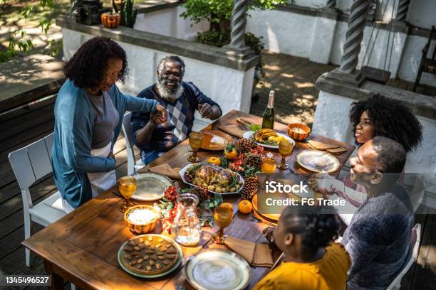 Senior Woman Saying Grace Before Thanksgiving Lunch At Home Stock Photo - Download Image Now