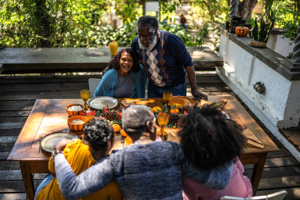 istock Senior man saying grace before Thanksgiving lunch at home 1345496542