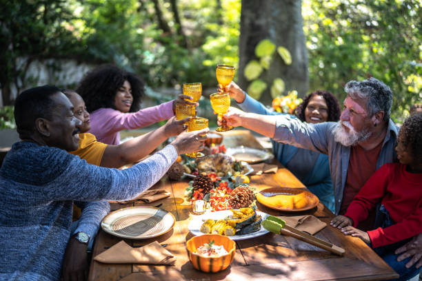 Family toasting on Thanksgiving at home - including special needs woman