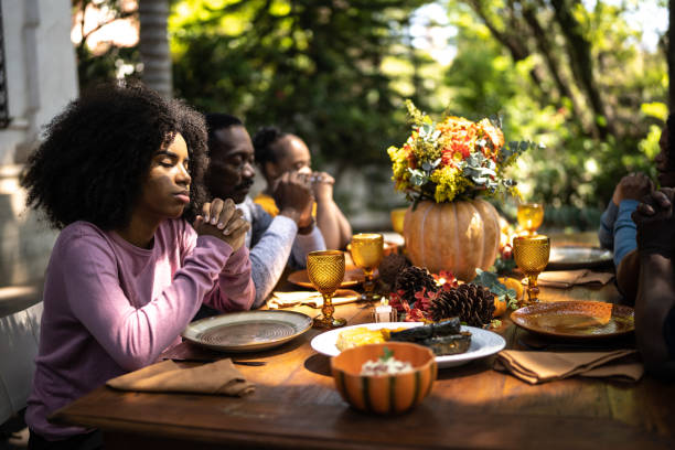 familie sagt gnade vor dem thanksgiving-mittagessen zu hause - 18 23 monate stock-fotos und bilder