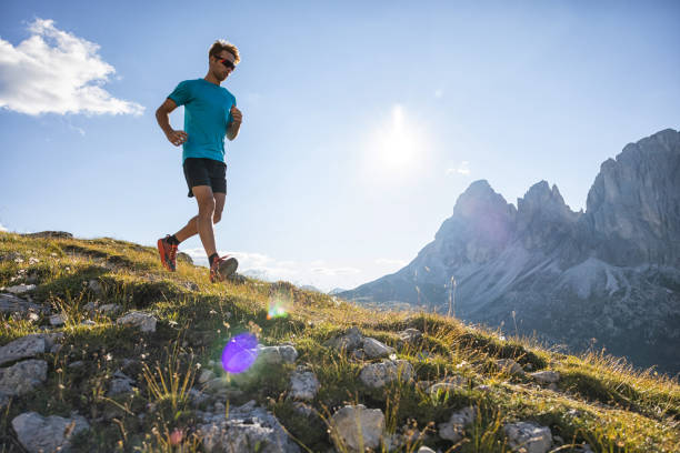 istock Young man trail running on the Dolomites mountain 1345501732