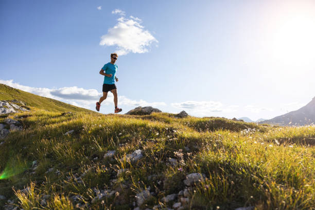 istock Young man trail running on the mountain, in slow motion 1345502616