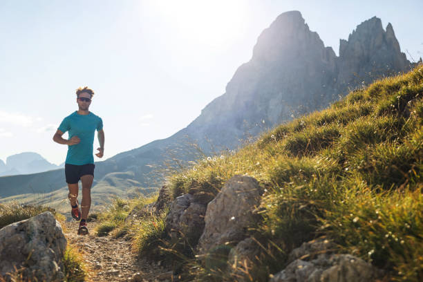 istock Young man trail running on the Dolomites mountain 1345502762