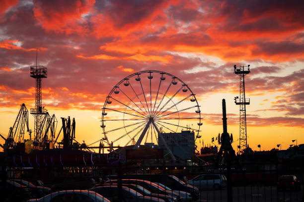 Vintage carnival with rides at sunset, 3d render.